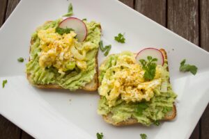 Scrambled eggs on avocado wholegrain toast